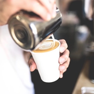 Pouring milk into a coffee